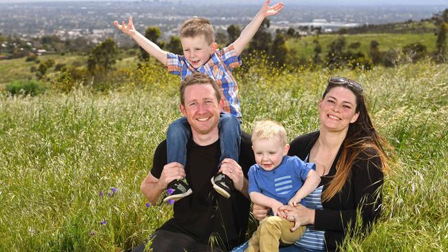 Don and Rebekah Reddin, of O’Halloran Hill, at the Happy Valley site yesterday with children Isaiah, 3 and Harvey, 2. “We would love for there to be a place (for activities) in walking distance of our house and have this land opened up to us to use.” Picture: Tom Huntley