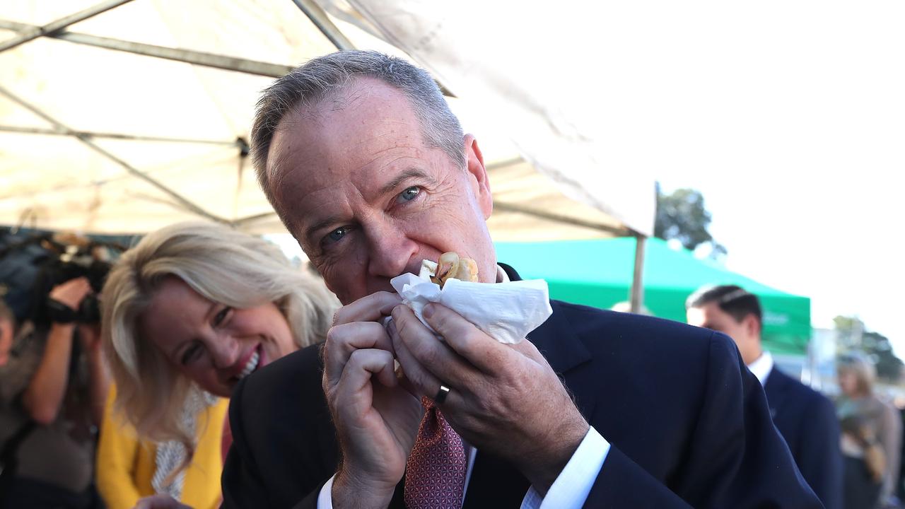 Opposition Leader Bill Shorten eating a sausage sandwich after voting in the 2019 election campaign. Picture Kym Smith