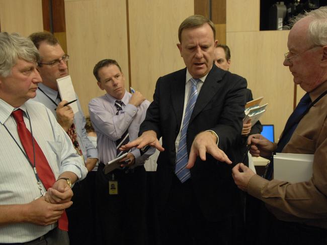 Treasurer Peter Costello surrounded by journalists Dennis Shanahan (L), Steve Lewis, Mark Kenny and Paul Kelly as he 'sells' his budget in the 'Lock-up' at Parliament House in Canberra.