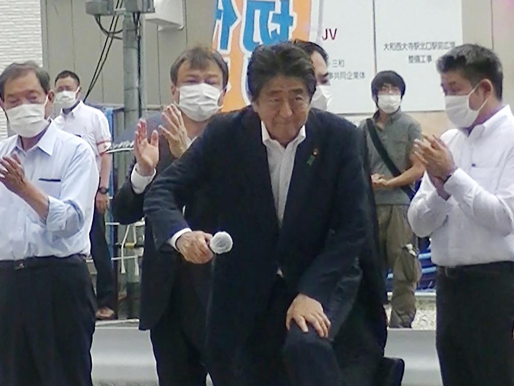 Shinzo Abe’s gunman could be seen looking on in the background at the event.