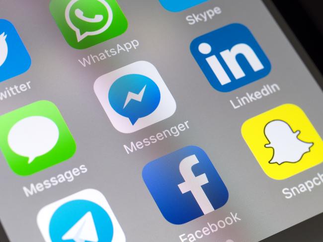 London, UK - November 11 2016: The buttons of Facebook Messenger, Messages, Linkedin, Facebook, Snapchat, Skype, Whatsapp and Twitter social media apps on the screen of a mobile phone