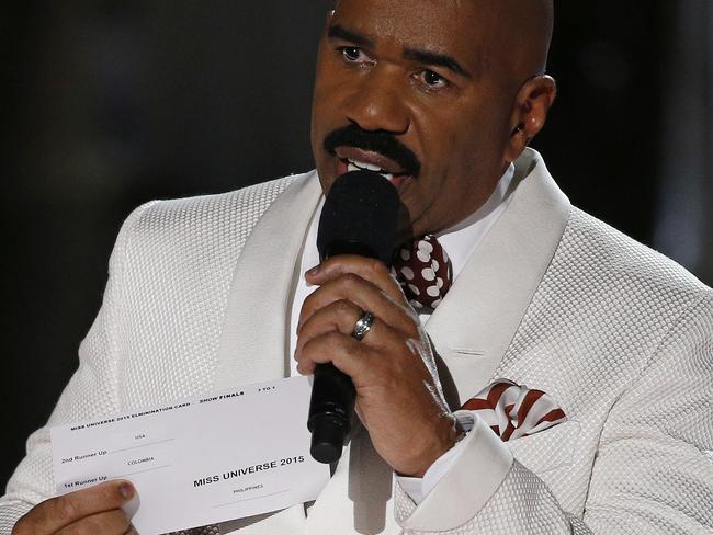 Steve Harvey holds up the card showing the names of the contestants and where they finished. Picture: John Locher/AP