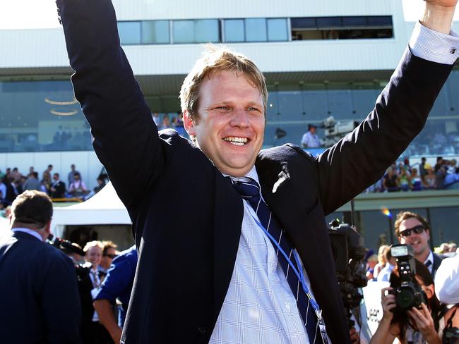 Jockey Nathan Berry rides no1 Unencumbered to the win in the Magic Millions 2YO Classic on the Gold Coast and Bjorn Baker celebrates the win. Pics Adam Head