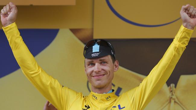 Germany's Tony Martin celebrates on the podium after the fourth stage of the Tour de France.