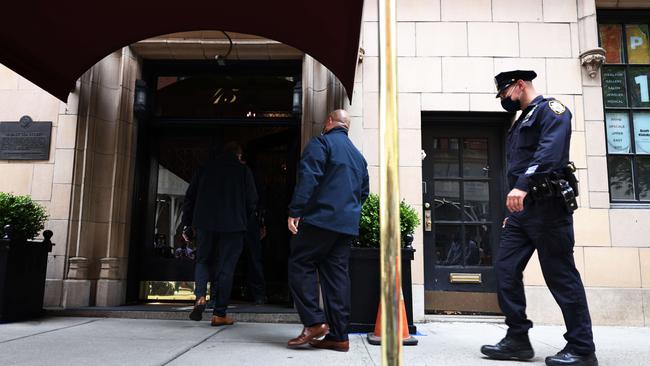 NYPD officers enter the apartment complex where the residence of Rudy Giuliani, former President Donald Trump's personal lawyer, is located in Manhattan. Picture: Getty Images