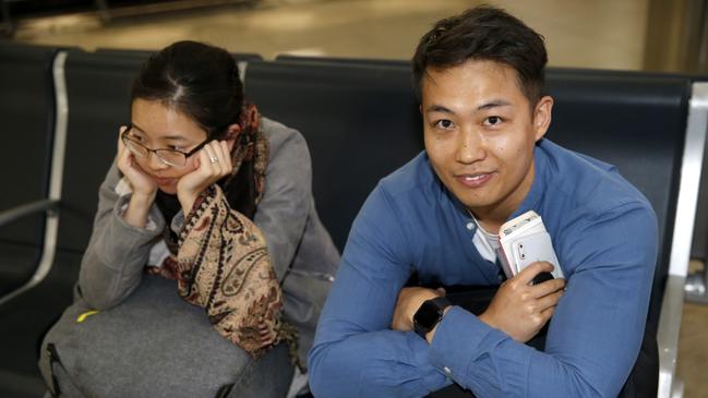 Fiona Lee and Andrew Mak wait for a flight after their Qantas flight from Tokyo to Sydney made an emergency landing at Cairns airport PICTURE: ANNA ROGERS