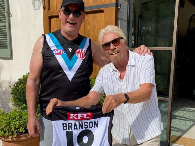 Richard Branson and David Koch with a Port Adelaide guernsey, cheering on the team from Greece ahead of tomorrow’s final. Picture: Supplied