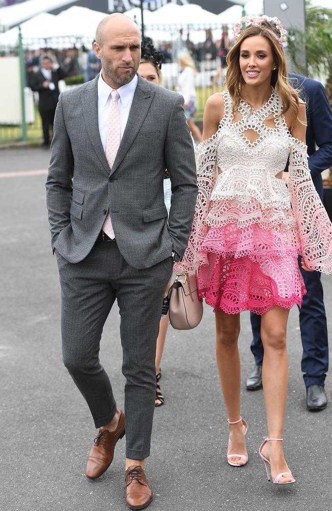 Chris and Rebecca Judd arriving at Caulfield. Picture: Julian Smith, AAP Image.