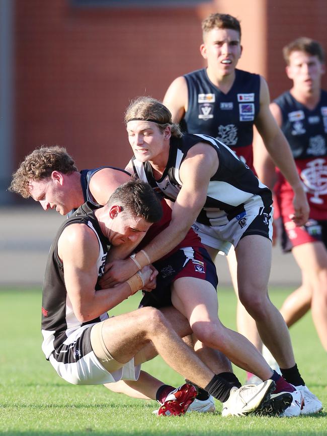 Sandhurst’s Nicholas Stagg tackles Castlemaine’s Bailey Henderson. Pictures Yuri Kouzmin