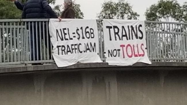 Doncaster rail supporters protest the State Government’s North East Link project with a banner drop at the Eastern Freeway.