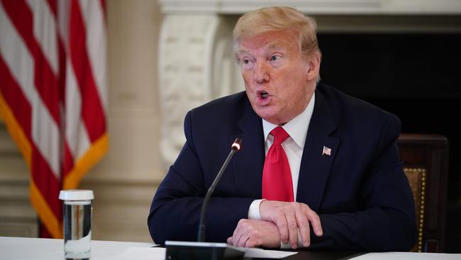 Donald Trump takes part in a roundtable discussion with industry executives on “Opening Up America Again” in the State Dining Room of the White House in 2020.