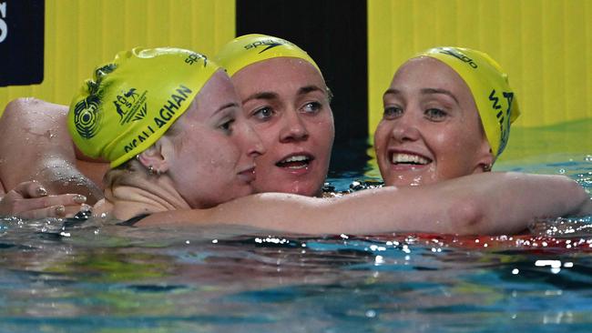 Ariarne Titmus with Mollie O'Callaghan and Madi Wilson after a trifecta. Picture: Andy Buchanan / AFP