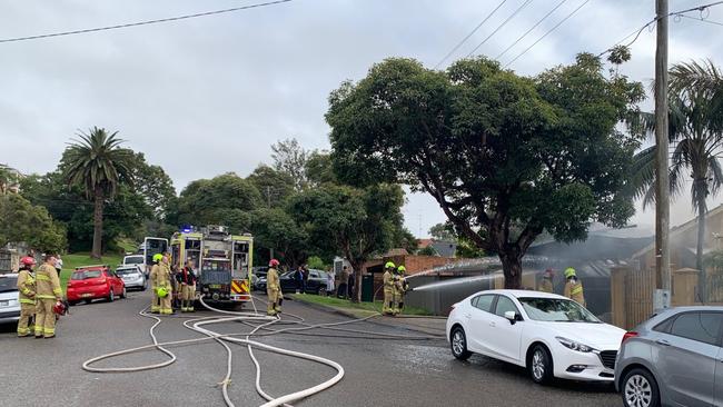 Firefighters fight to contain a garage fire in Seaforth. Picture: Max Agency