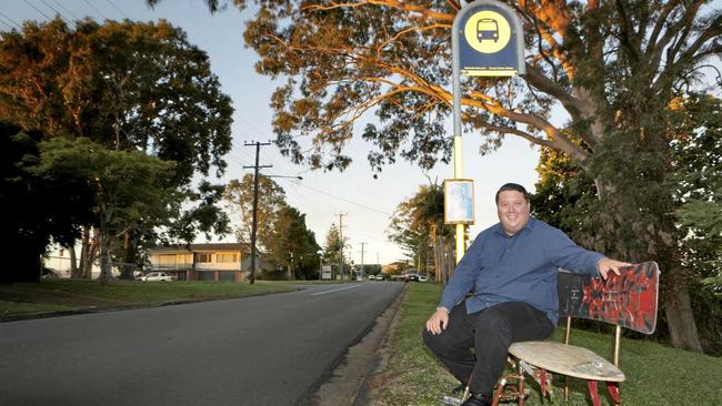 Cr Reece Byrnes admires a Local Artists attempt to provide public seating for Bilambil Heights commuters. It is constructed from two half surfboards, a snowboard and all mounted on the frame of an old wheelchair. Picture: Richard Mamando