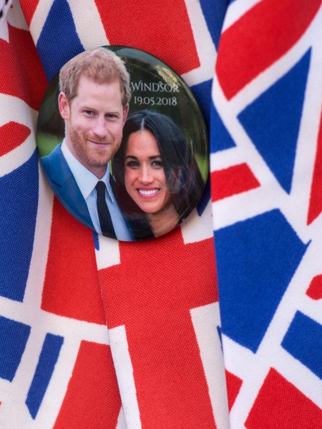 A bin badge is worn by a Royal fan waiting along the proposed route of the wedding carriage procession. Picture: AFP.