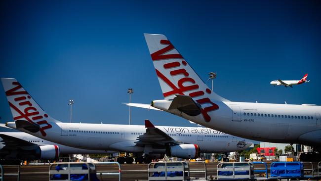 Virgin Australia aircraft are seen parked on the tarmac at Brisbane International Airport. Picture: Patrick Hamilton