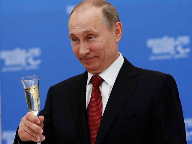 SOCHI, RUSSIA - MARCH 13: Russian President Vladimir Putin holds a glass of champagne during a lunch hosted by the office of the Russian President Vladimir Putin for the Presidents of the International Paralympic Committee member organisations during the 2014 Sochi Paralympic Games on March 13, 2014 in Sochi, Russia.  (Photo by Harry Engels/Getty Images)