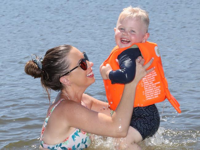 Cooling off from the searing heat in the Broadwater at Paradise Point is mother and son Heidi Sebastian and Charlie 2 from Hope Island. Heidi couldn't think of a better way to get Charlie to burn off some energy, cool down,  and learn at the same time.  . . Picture Glenn Hampson