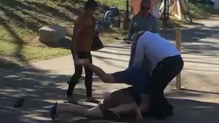 Footage has emerged of two men fighting on a footpath outside a polling booth in Redbank.