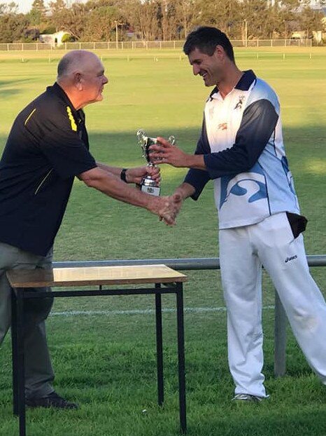 Former Crows champ turned Port Adelaide coach Nathan Bassett collects the premiership cup. Pictures: Grange CC