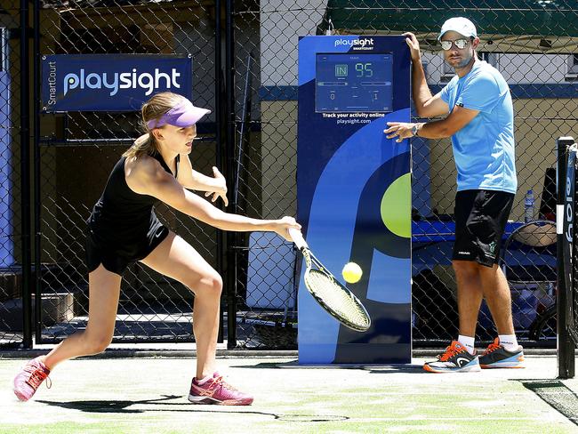 L to R: Tennis Player Delphi Hinchcliffe -13 with Tennis Coach  Adrian Montgomery monitoring her player stats at the Play sight courtside Kiosk. Centennial Parklands Sports Centre is launching the first PlaySight Smart Tennis Court in NSW which can measure players speed and performance. Picture: John Appleyard