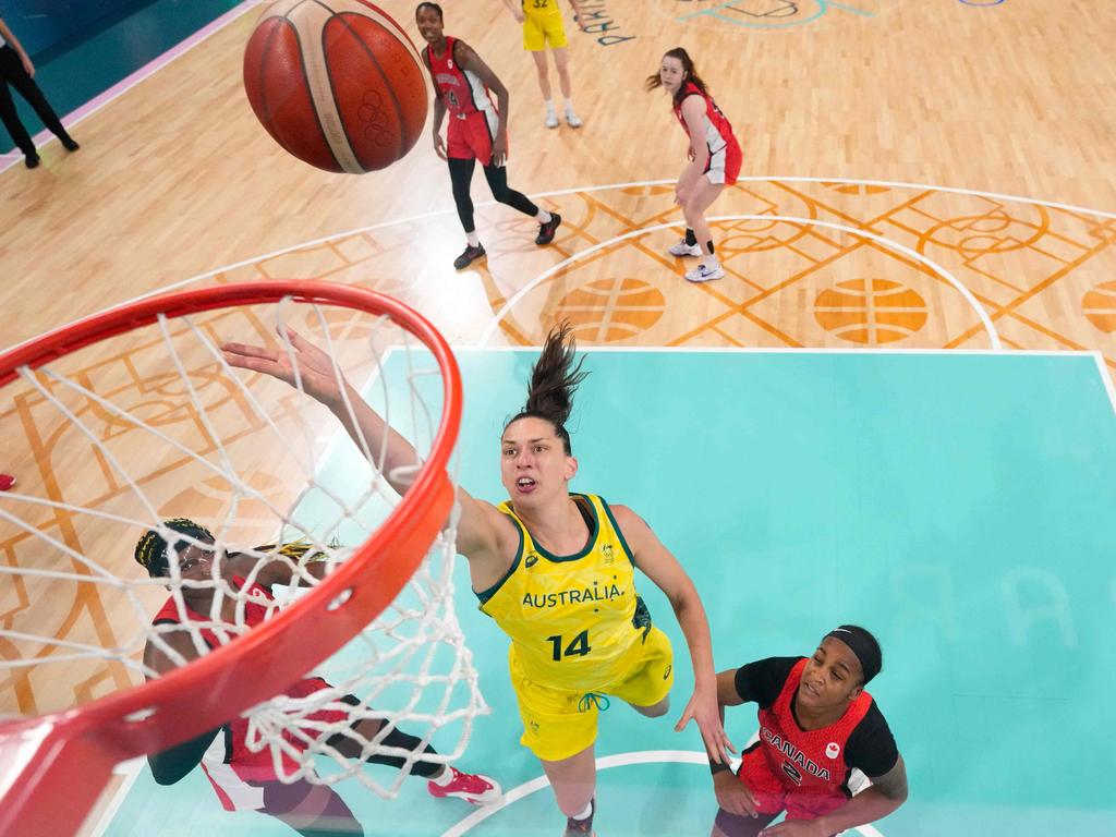 Australia's #14 Marianna Tolo lays up the ball as Canada's #02 Shay Colley (R) looks on as the Opals end the Canadian hoodoo. Picture: POOL/AFP