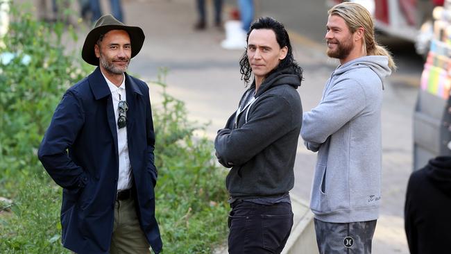 Actors Chris Hemsworth and Tom Hiddleston with director Taika Waititi (in hat) on the set of Thor in Brisbane's CBD. Picture: Jack Tran