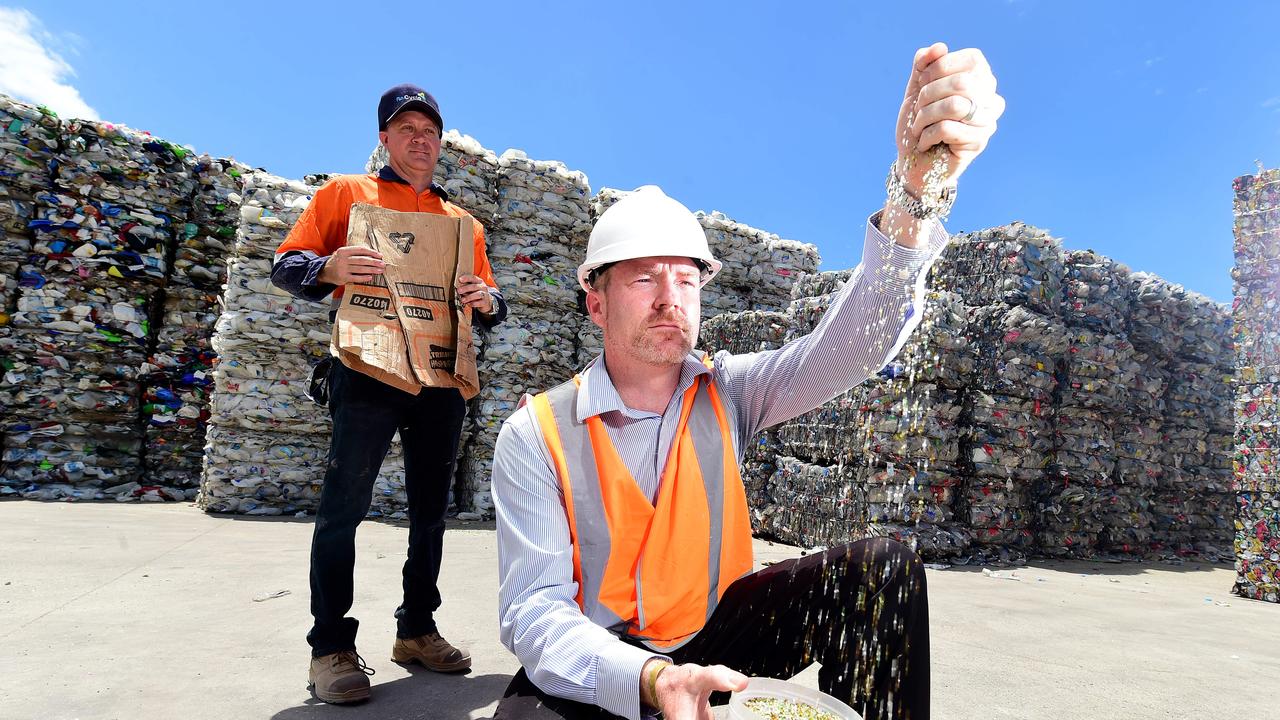 Matthew McCarthy, manager Townsville Waste Services (white hard hat) with Michael Jarvis, manager of Townsville Materials Recovery Facility at the Re.Group complex with recyclable items.