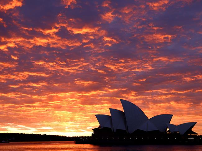 SYDNEY, AUSTRALIA - NewsWire Photos JULY 28, 2021: The sky was a blaze this morning over the Sydney Opera house. Picture: NCA NewsWire / Damian Shaw