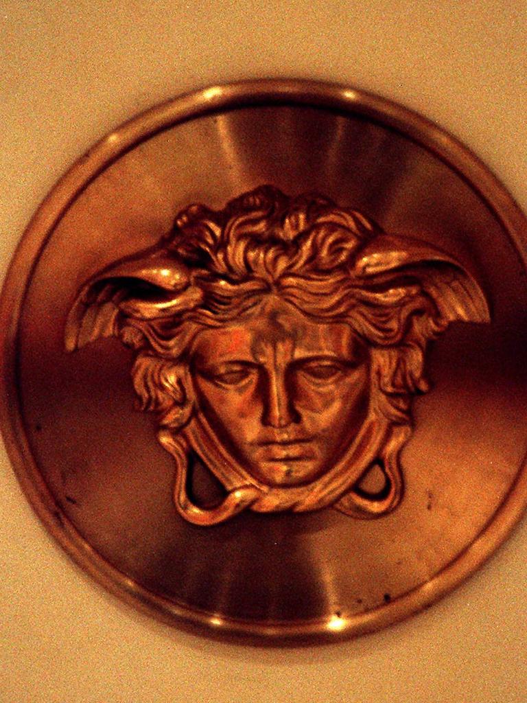 The Versace fashion house logo with Medusa’s image.