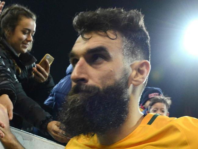 (FILES) This file photo taken on June 8, 2016 shows Australian captain Mile Jedinak leaving the field after their World Cup football Asian qualifying match against Saudi Arabia at the Adelaide Oval in Adelaide. Australia's hopes of qualifying for next year's World Cup have been dealt a blow after injury concerns forced skipper Mile Jedinak out of a 23-man squad to face Japan and Thailand in crunch qualifiers on August 23, 2017. / AFP PHOTO / BRENTON EDWARDS / --IMAGE RESTRICTED TO EDITORIAL USE - STRICTLY NO COMMERCIAL USE--