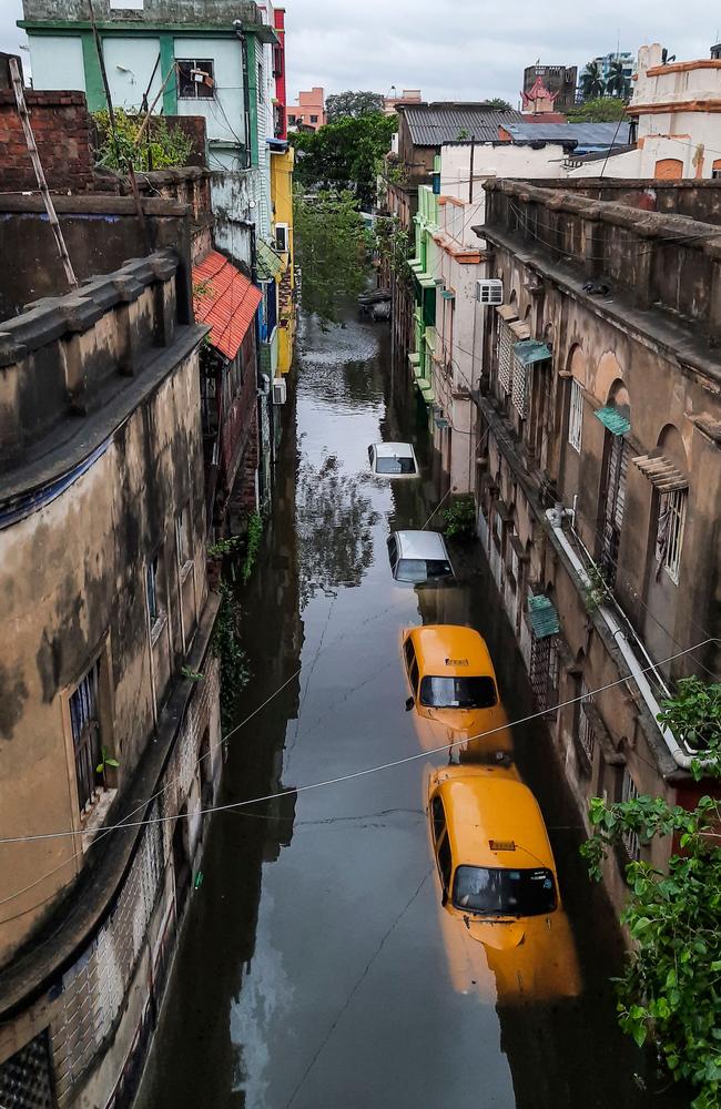 Submerged vehicles in a flooded alleyway after the landfall of Cyclone Amphan in Kolkata. Picture: Satyaki Sanyal/AFP