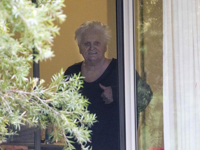 Patricia Shea (76) who is COVID-19 positive gives the thumbs up to her son who is outside the fence from the window of her accomodation at Newmarch House residential care in Caddens, Sydney . 3rd May, 2020.  Picture by Damian Shaw