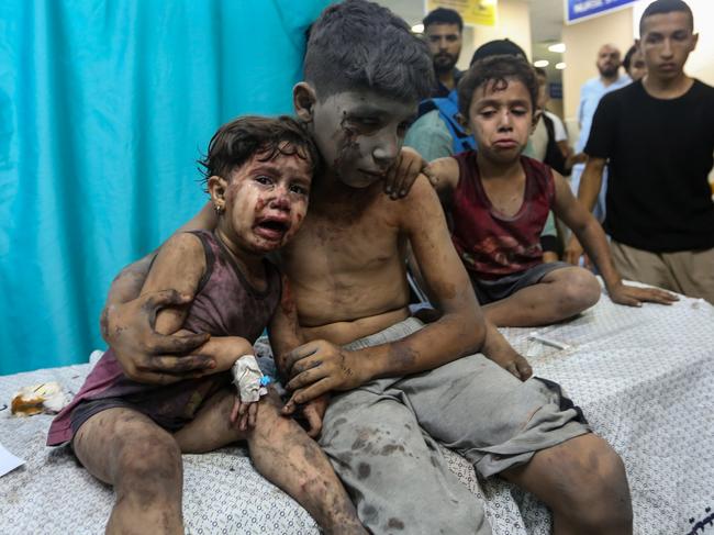 Palestinian children injured in Israeli air raids arrive at Nasser Medical Hospital in Khan Yunis, in the southern Gaza Strip. Picture: Getty Images