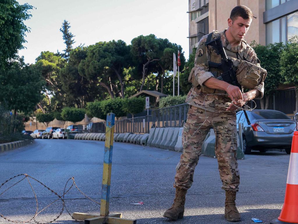 A Lebanese army soldier uses razor wire to block an entrance of a Beirut southern suburb on September 17, 2024. Picture: AFP