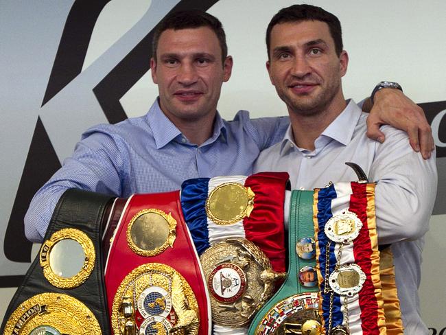 Ukranian heavyweight boxers, brothers Vitali, left, and Wladimir Klitschko display their complete set of heavyweight world title belts at a press conference in Moscow, Russia, on Friday, July 8, 2011. Wladimir beat David Haye on points in Hamburg, Germany on July 2, 2011, to claim the WBA heavyweight title and now the Ukrainian brothers have all six world heavyweight title belts. (AP Photo/Ivan Sekretarev) .