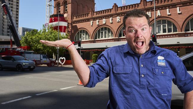 He’s got the whole Christmas world in his hand.... Andrew 'Cosi' Costello outside the Central Market in Adelaide while Big Santa is being installed. Picture: Matt Loxton