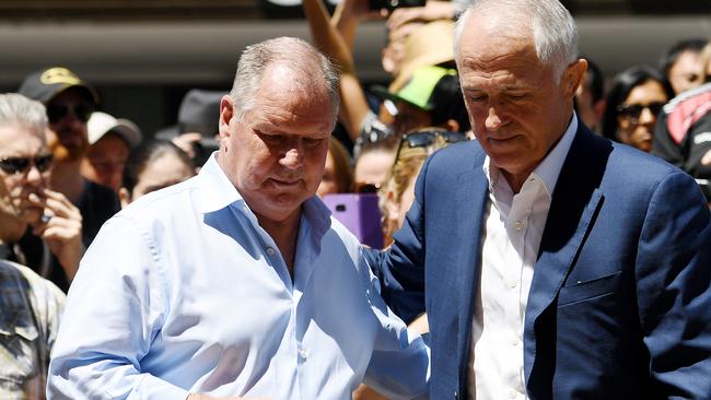 Prime Minister Malcolm Turnbull and Lord Mayor Robert Doyle gaze at the floral shrine on Bourke St.