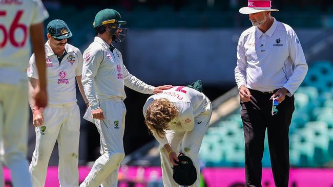 Pucovski reacts after being hurt while fielding during the fifth day in Sydney.