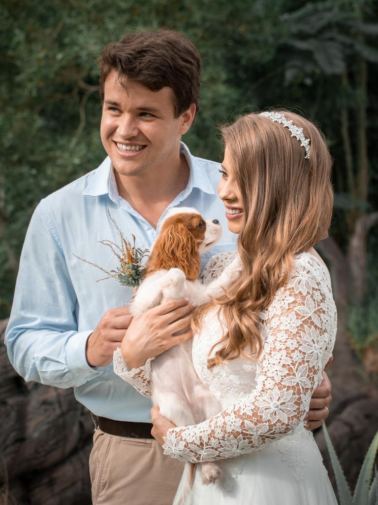 Chandler Powell and Bindi Irwin on their wedding day holding “Piggy”. Picture: Kate Berry