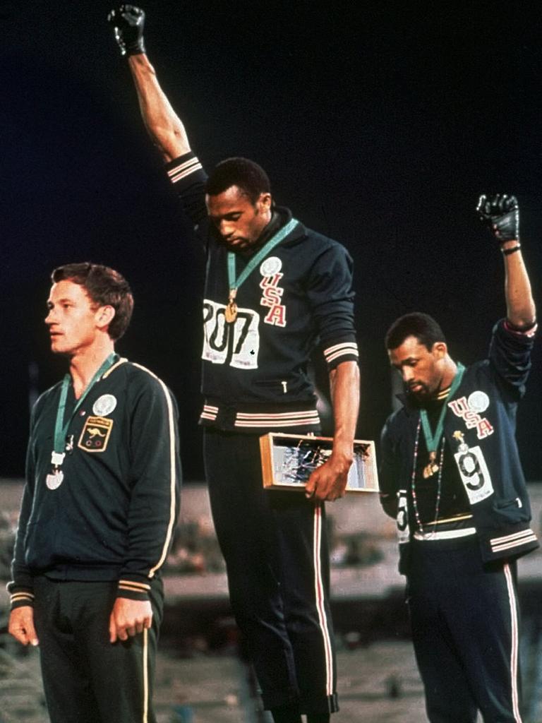 AUS50TH 1968:  Extending gloved hands skyward in racial protest, US athletes Tommie Smith (centre), and John Carlos stare downward during the playing of the Star Spangled Banner after Smith received the gold and Carlos the bronze for the 200 meter run at the Summer Olympic Games in Mexico City on Oct. 16, 1968. Australian silver medalist Peter Norman is at left. 1968 Olympic Games. Olympics. Salute. Protest. 200m. Medal ceremony. (AP Photo/FILE) Picture: Supplied