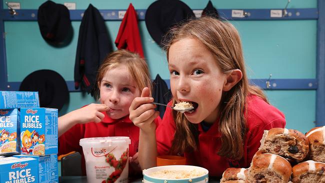 Schools are being encouraged to hold a big breakfast to raise money for the Feed Melbourne appeal. Richmond Primary school students Claudia and Audrey tuck into breakfast. Picture: Ian Currie.