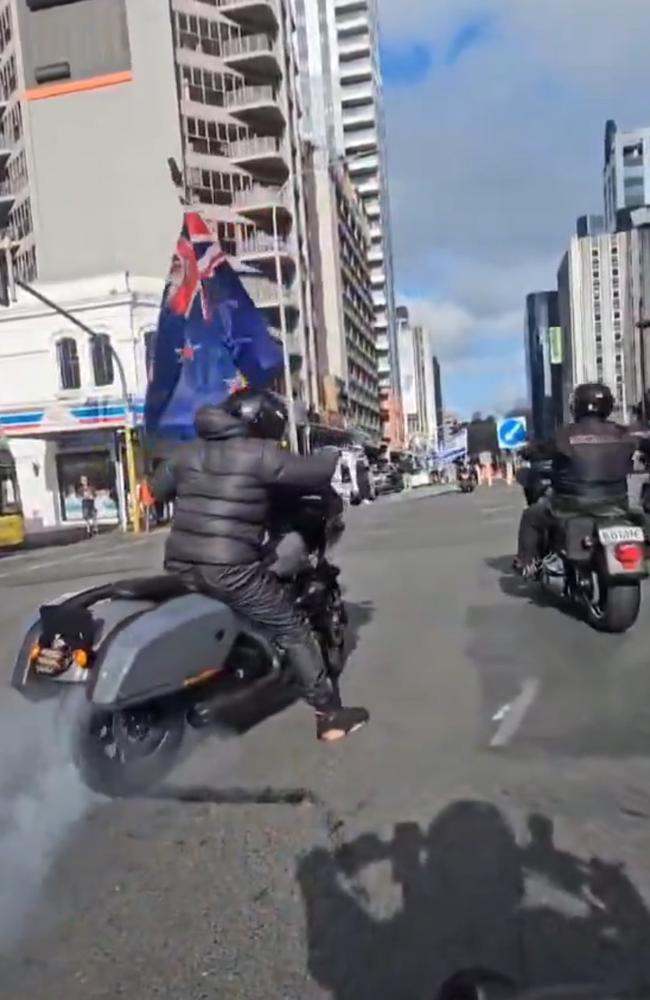 Men on motorbikes were doing burnouts as protesters screamed at the rally.