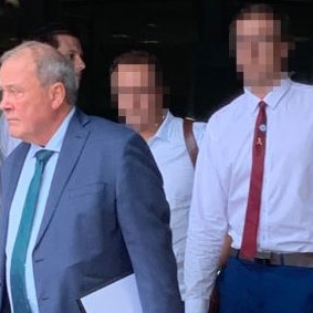 The Gold Coast lifesaver charged with rape (right) is accompanied by his father (centre) and lawyer outside court. Picture: Greg Stolz