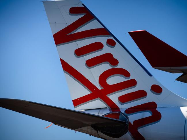 Virgin Australia aircraft are seen parked on the tarmac at Brisbane International airport on April 21, 2020. - Cash-strapped Virgin Australia collapsed on April 21, making it the largest carrier yet to buckle under the strain of the coronavirus pandemic, which has ravaged the global airline industry. (Photo by Patrick HAMILTON / AFP)