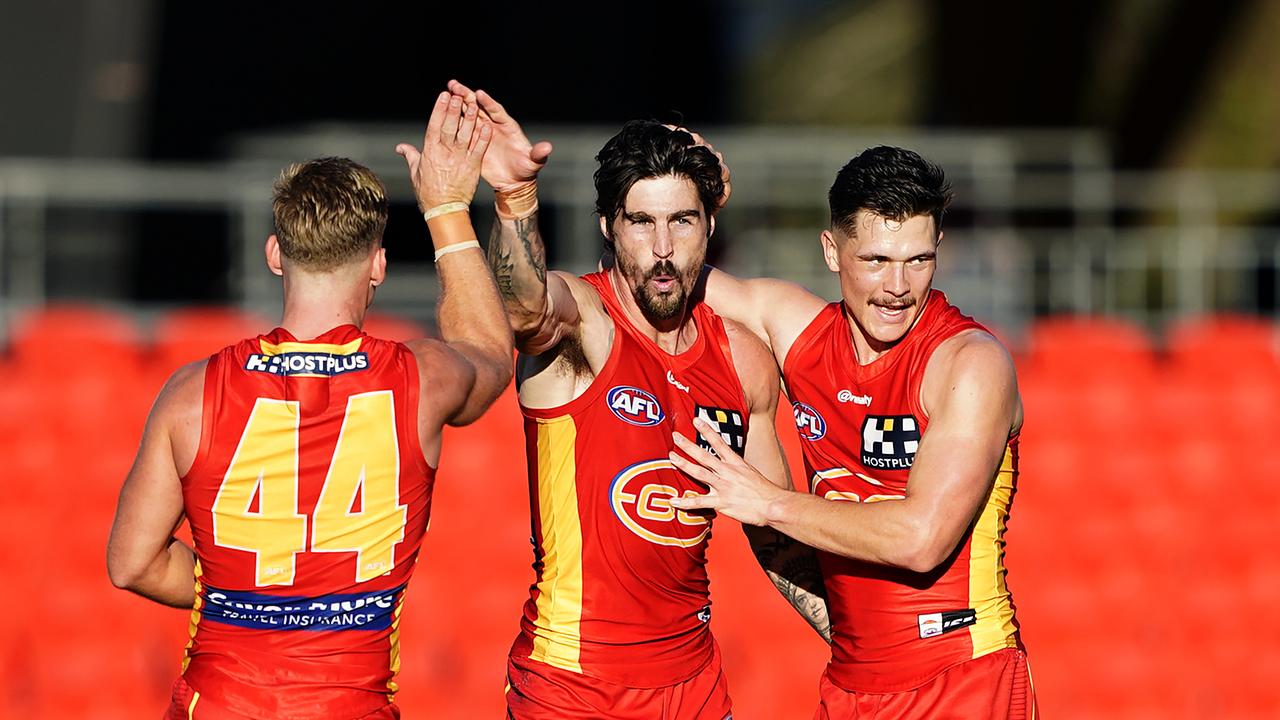 Alex Sexton of the Suns (centre) reacts after kicking a goal during the Round 3 AFL match between the Gold Coast Suns and the Adelaide Crows at Metricon Stadium on the Gold Coast, Sunday, June 21, 2020. (AAP Image/Dave Hunt) NO ARCHIVING, EDITORIAL USE ONLY