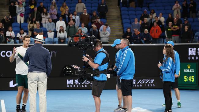 MELBOURNE, AUSTRALIA - JANUARY 19: Andy Murray of Great Britain gives an after match TV interview (to the right of picture the clock shows the match time of 5 hours and 45 minutes ) after his five set victory in their round two singles match against Thanasi Kokkinakis of Australia during day four of the 2023 Australian Open at Melbourne Park on January 19, 2023 in Melbourne, Australia. (Photo by Clive Brunskill/Getty Images)