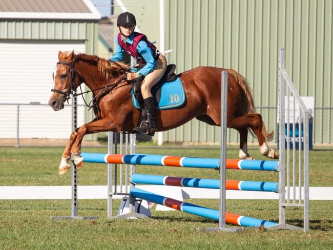 Lotus Locke clears the oxer at the PQC State Showjumping Championships 2023.