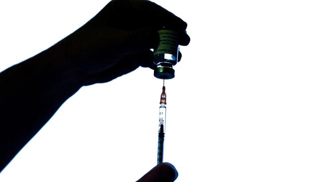 A health worker prepares an injection. (Photo by ALAIN JOCARD / AFP)