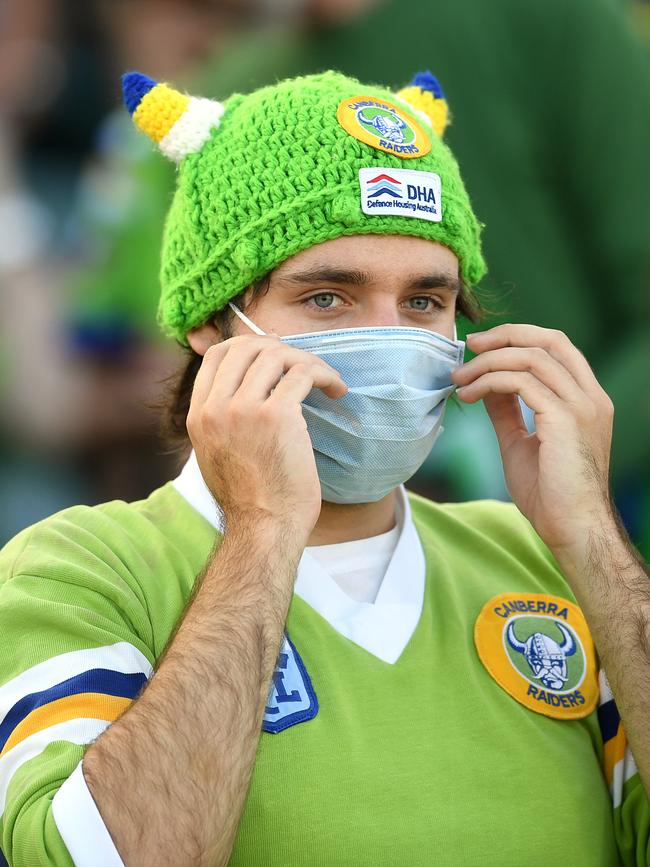 A Canberra Raiders fan wears a mask in the stands at the teams round one NRL clash on Friday. Picture: AAP/Lukas Coch